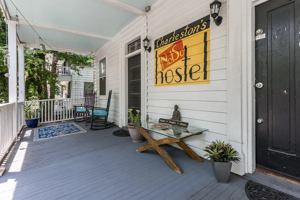 The hand-painted porch and sign of Charleston's NotSo Hostel